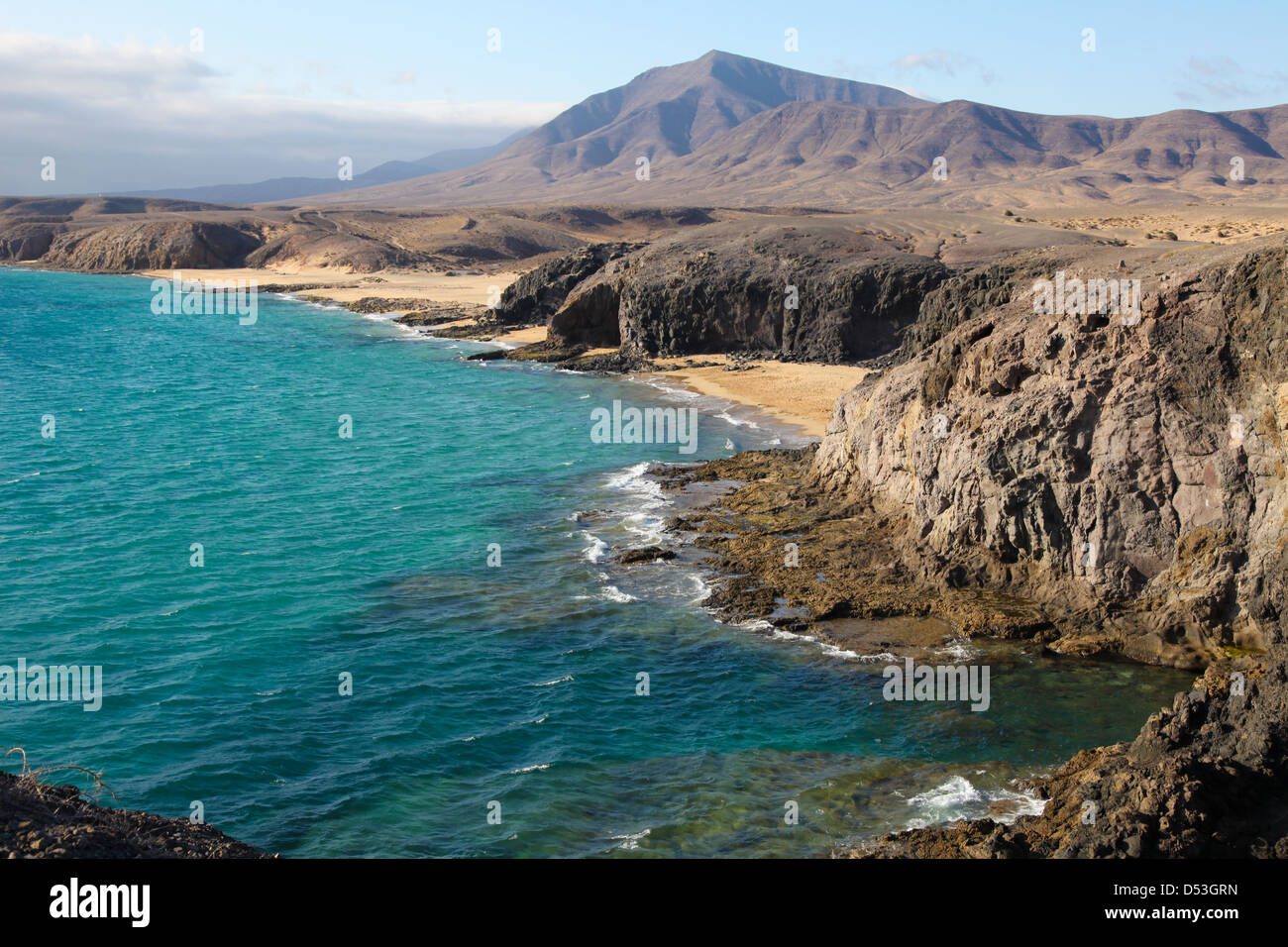 Beach and bay, Lanzarote, Spain - View of a beautiful bay and beach at the Playas de Papagayo, Lanzarote, Canary Islands, Spain. Stock Photo