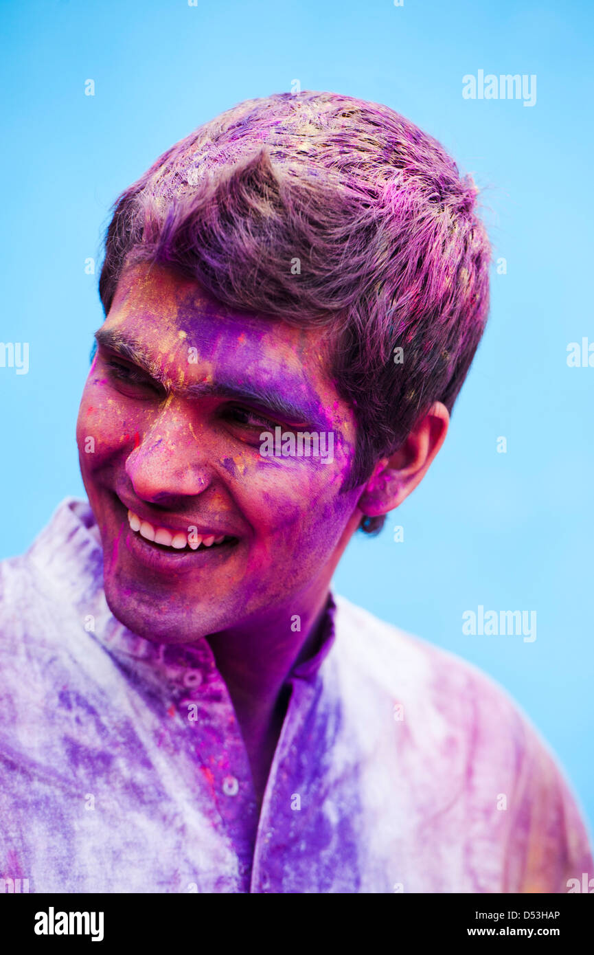 Smiling man with his face smeared with colors Stock Photo - Alamy