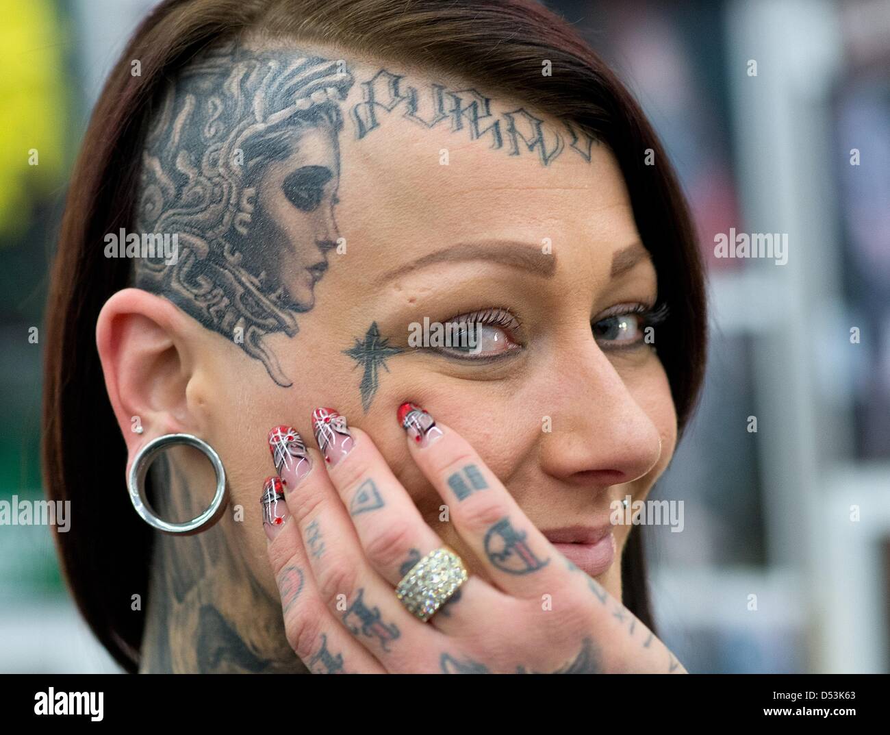 Frankfurt, Germany. 23rd March 2013. A young Dutch woman presents a tattoo  on her partly shaved head at the International tattoo Convention in  Frankfurt Main, Germany, 23 March 2013. More than 600