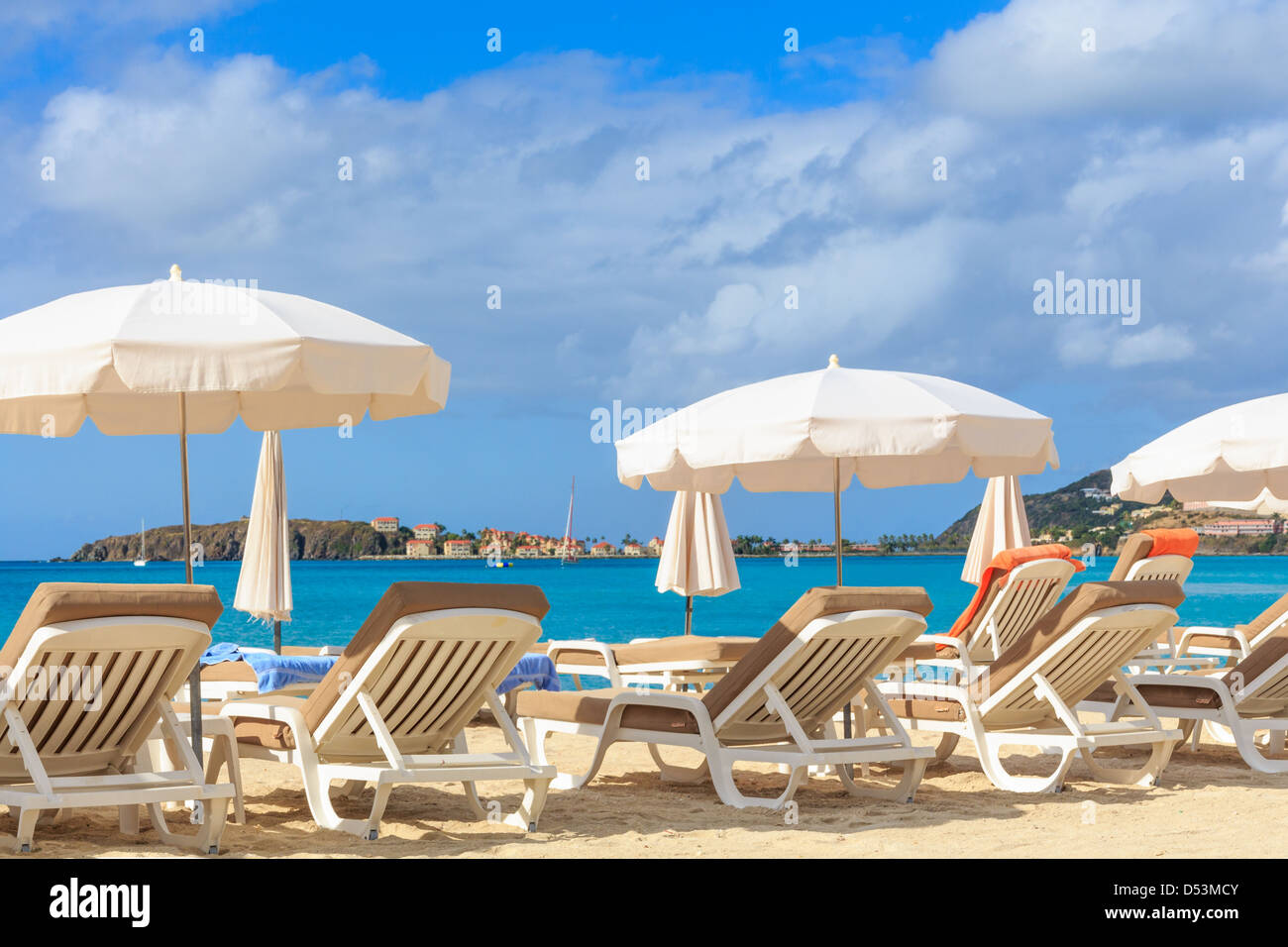 Beach chairs and parasols on a beach in a tropical paradise Stock Photo