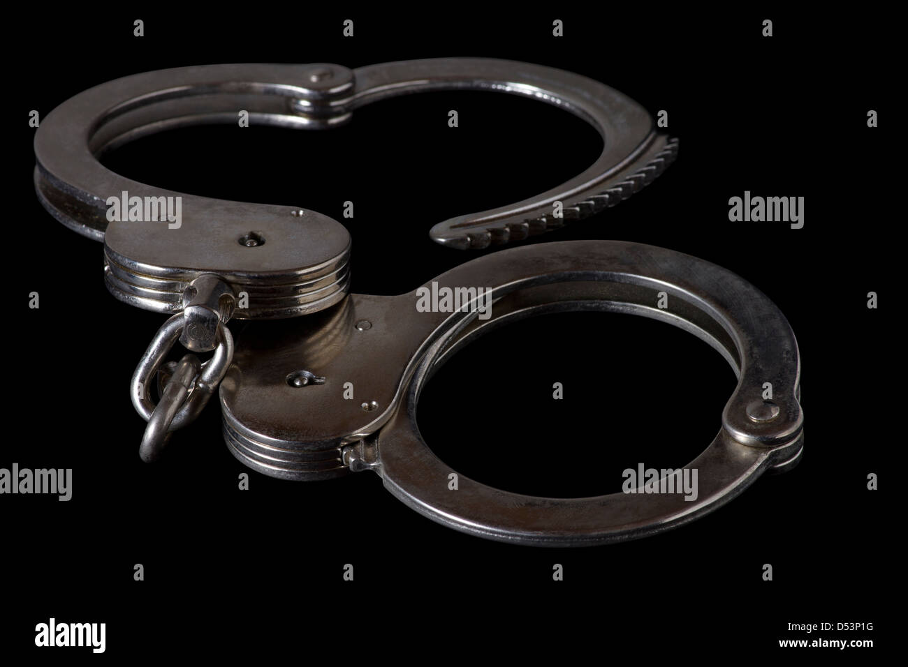 handcuffs,Metallic handcuffs,Isolated on black background Stock Photo