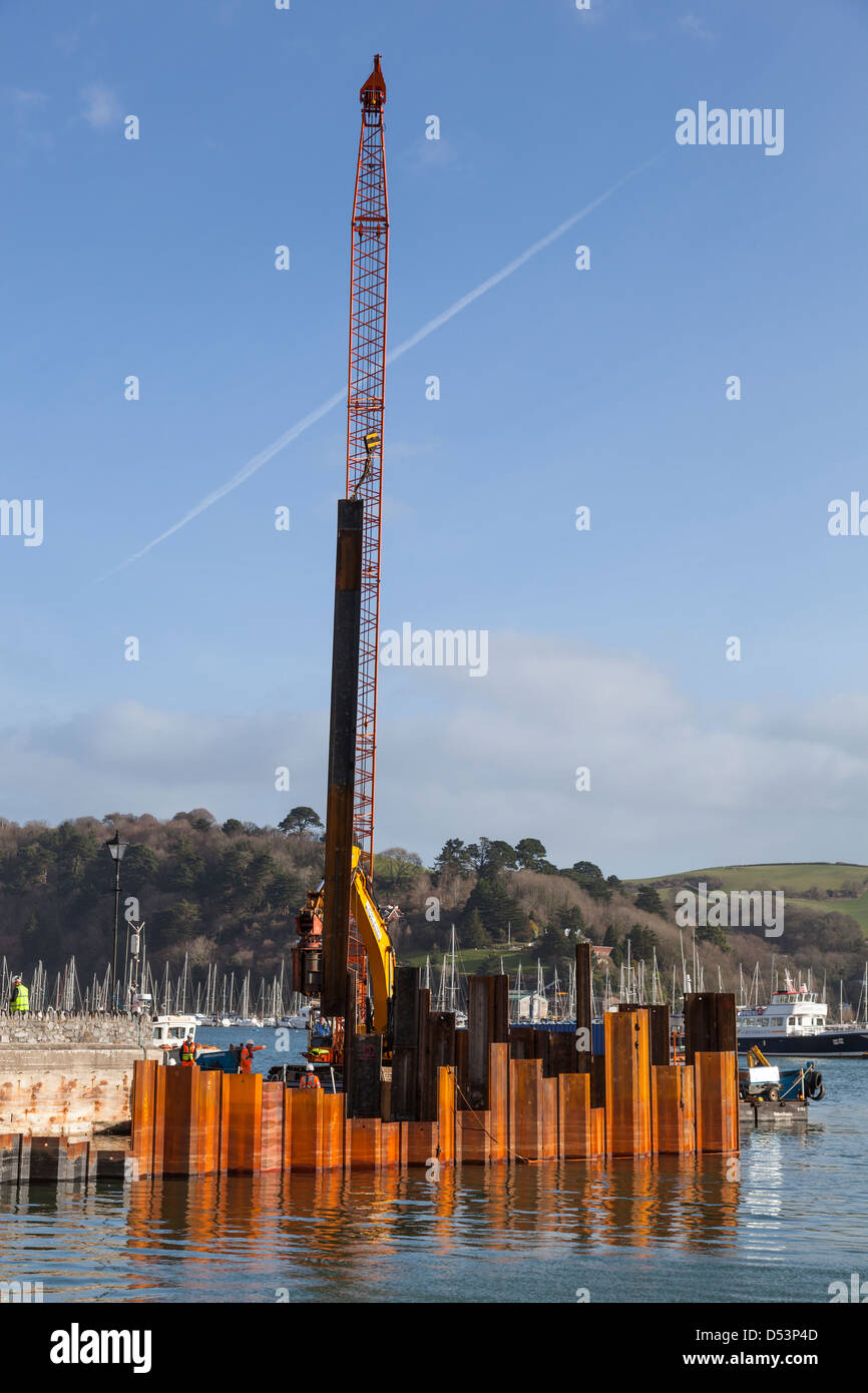 Steel sheets being installed by a pile driver during renovation of the landing slip for the Lower Dartmouth Ferry. Stock Photo