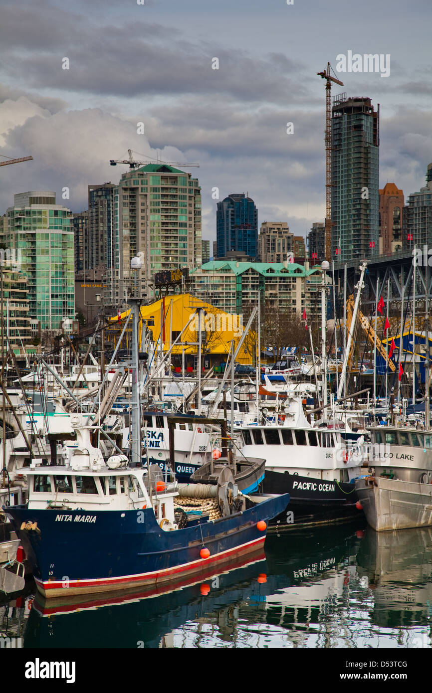 Commercial fishing boats against the Vancouver skyline, Canada Stock