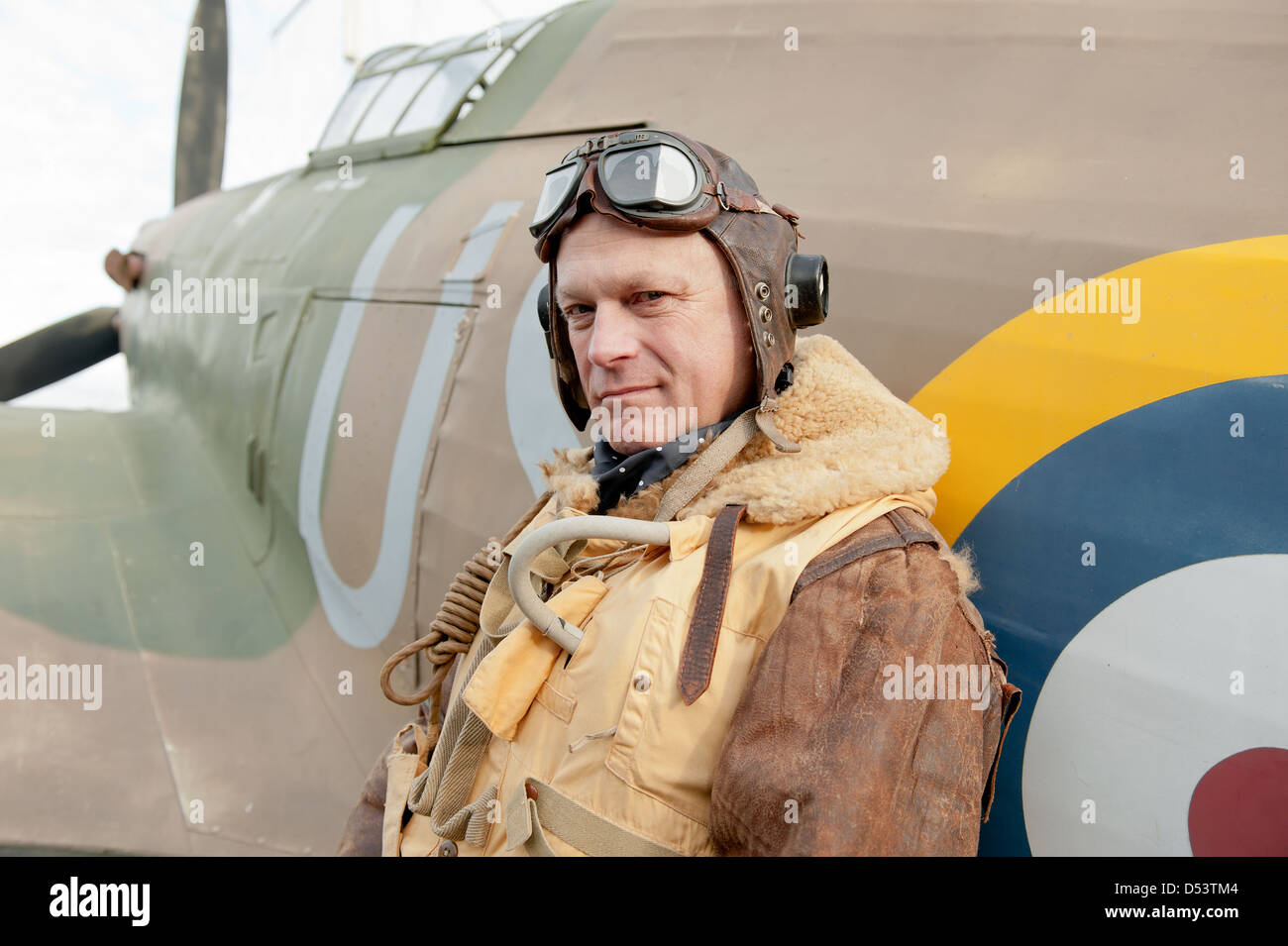 World War Two RAF pilot leaning against his Hurricane fighter aircraft. Stock Photo