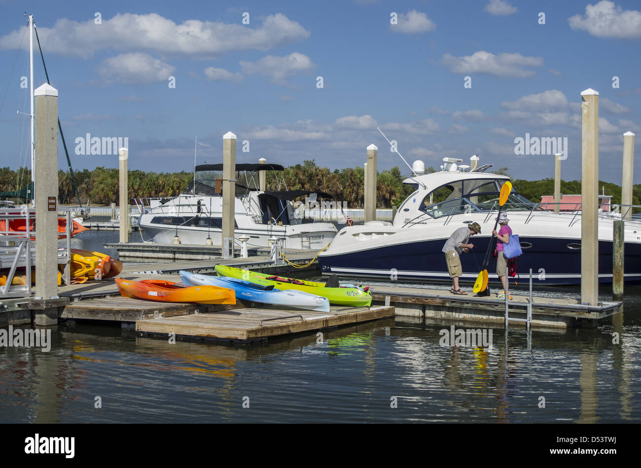 Couple at kayak rental on marina dock; Caladesi Island State Park Stock