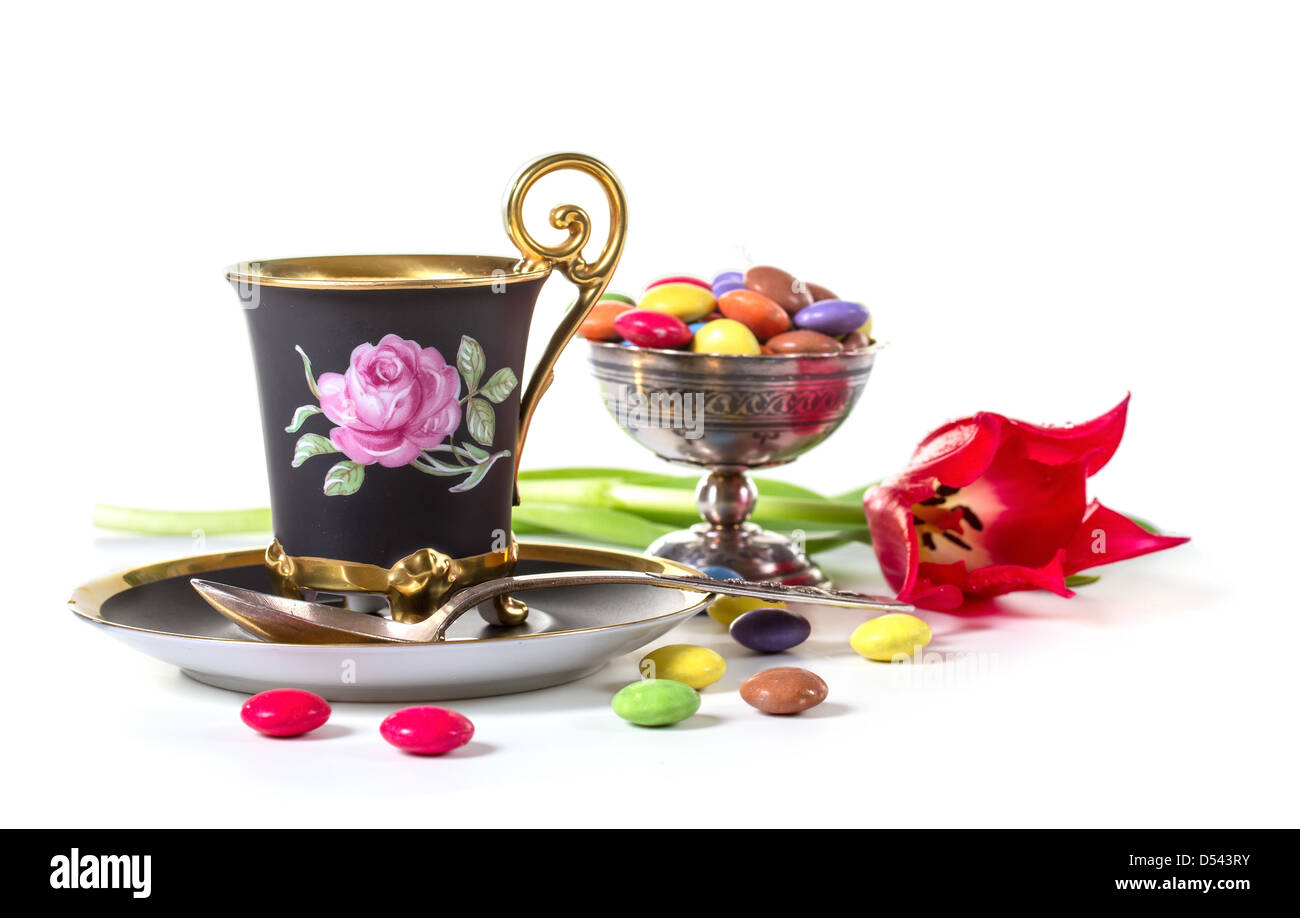 Cup of coffee with candies and a tulip Stock Photo