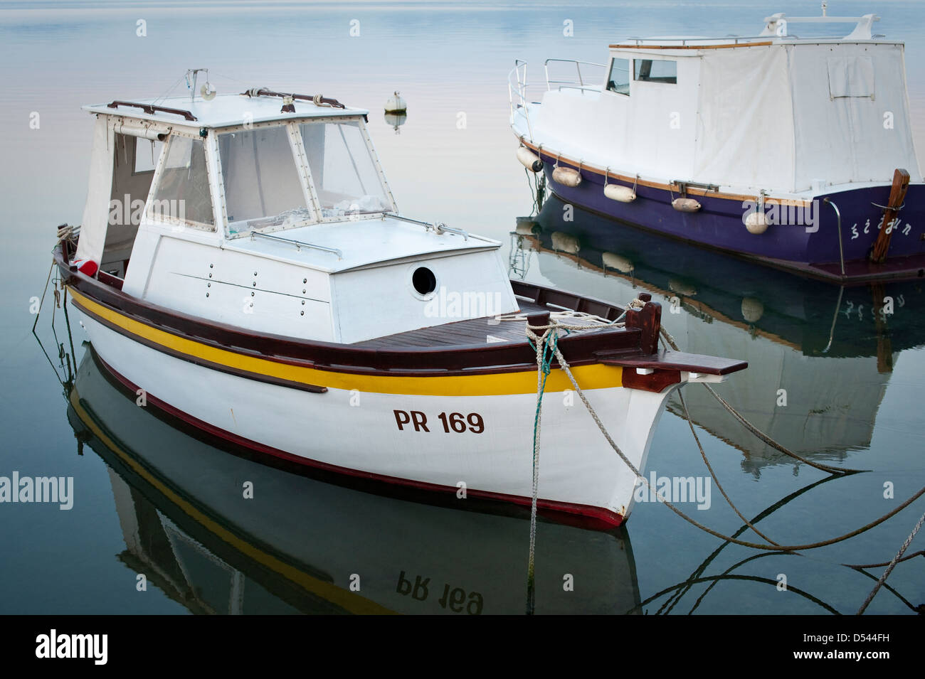 Motor boats at their moorings on a calm morning, Dalmatian coast Stock Photo
