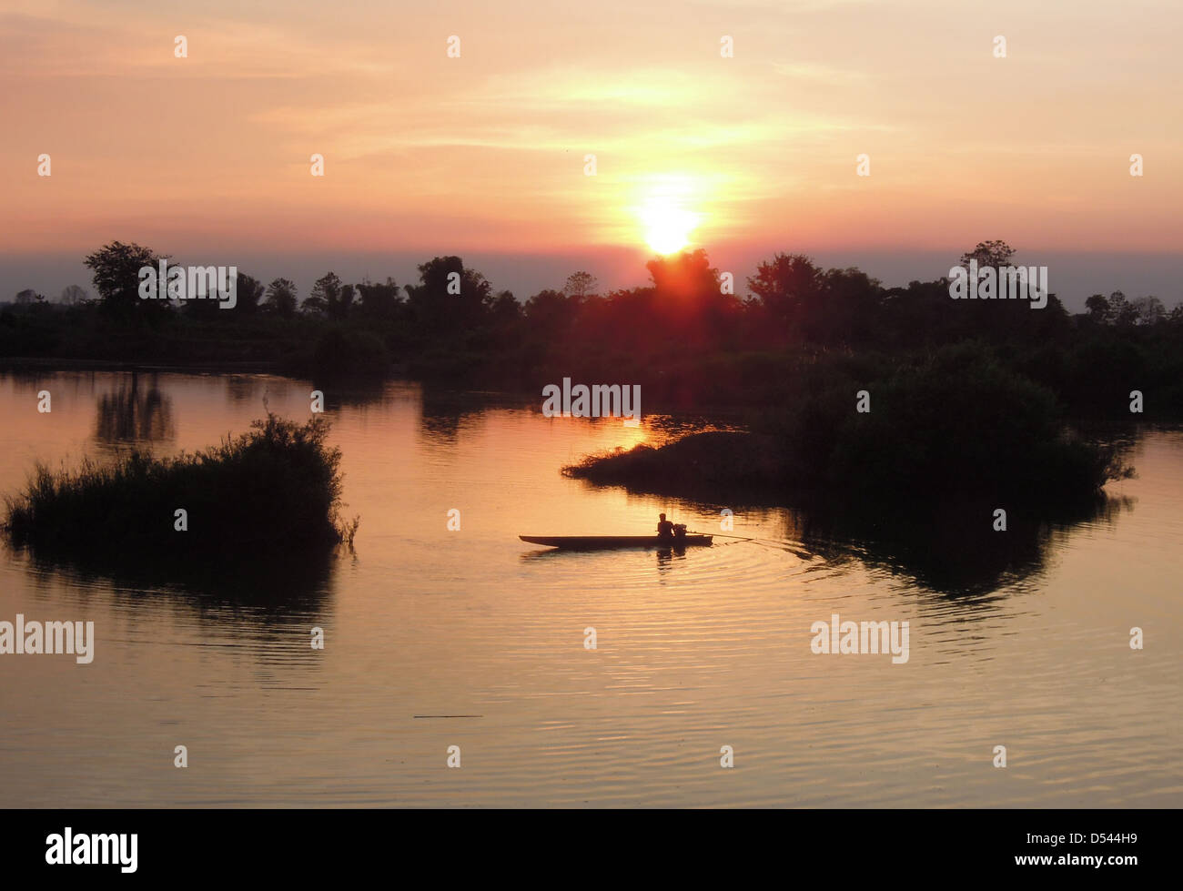 canoe at sunset on river Mekong at Don Khon island on Laos Stock Photo