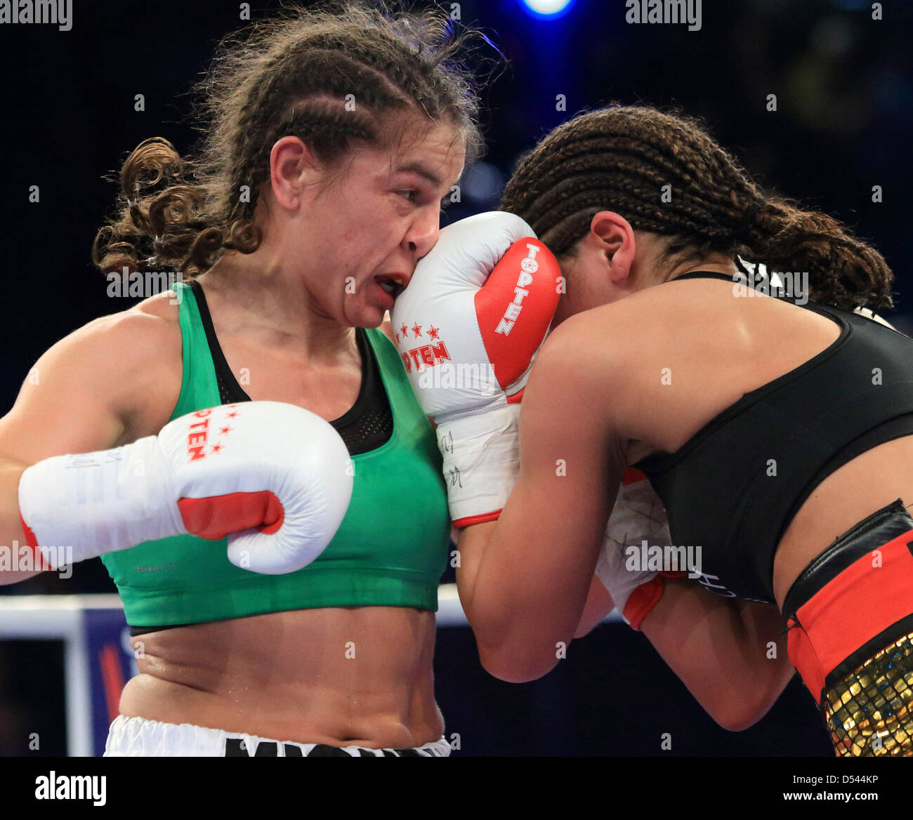 Magdeburg, Germany, 23rd March, 2013. US Melissa McMorrow (L) exchanges blows with German Nadia Raoui (R) in their WIBF flyweight title bout at GETEC-Arena in Magdeburg, Germany, late 23 March 2013. Melissa McMorrow won the fight. Photo: Jens Wolf/dpa/Alamy Live News Stock Photo