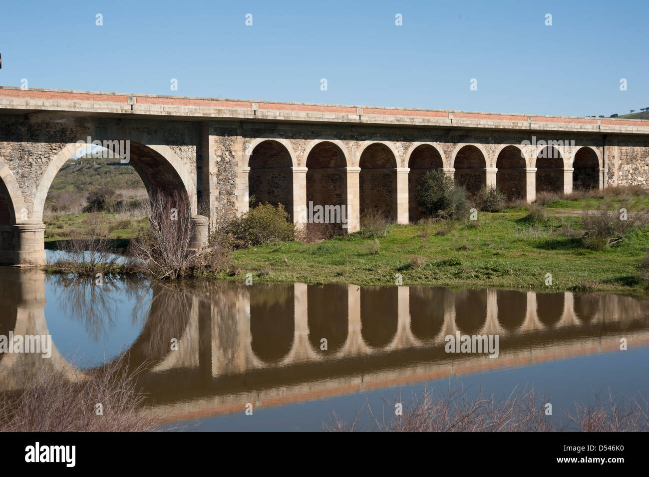 View of an old bridge over Rio Ardila, province of Badajoz, Spain. Stock Photo