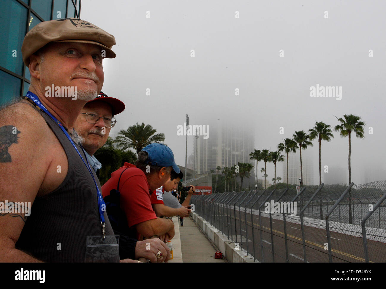 March 24, 2013 - St. Petersburg, Florida, U.S. - DIRK SHADD   |   Times  .Shane Hotchkiss (on left), 51, from Mechanicsville, Maryland, watches along with his brother-in-law Nick Powell, 68, from Clearwater, as fog descends over the city on a gloomy morning as race fans watch during the IndyCar warm-ups at the Honda Grand Prix of St. Petersburg Sunday morning (03/24/13). The rainy forecast remains a concern as the starts time for the race approaches. (Credit Image: © Dirk Shadd/Tampa Bay Times/ZUMAPRESS.com) Stock Photo