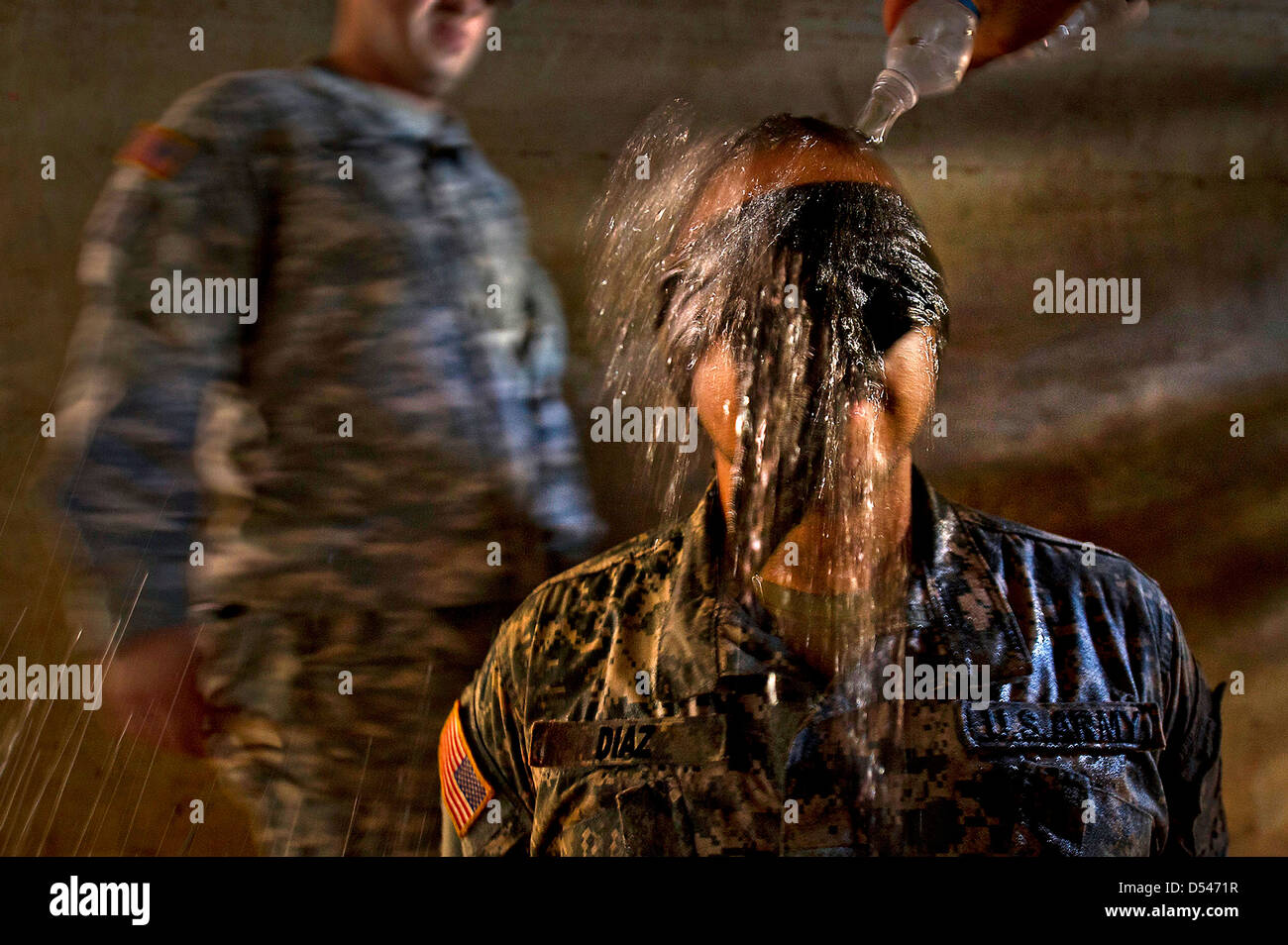 US Army Sgt. Fernando Diaz blind folded has ice-cold water dumped over his head during a mock interrogation simulating water boarding August 30, 2012 at Schofield Barracks in Wahiawa, Hawaii. Stock Photo