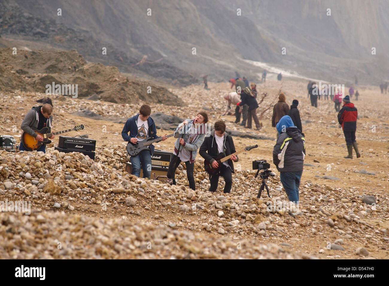Rock band record music video on beach Stock Photo Alamy