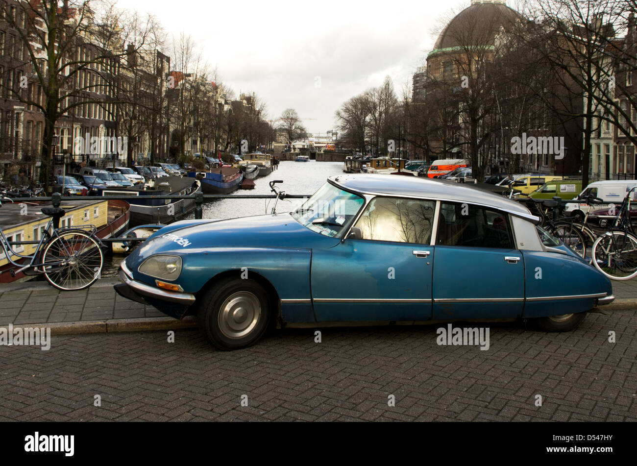 A old citroen ds sedan on a bridge over a canal in Amsterdam. Stock Photo