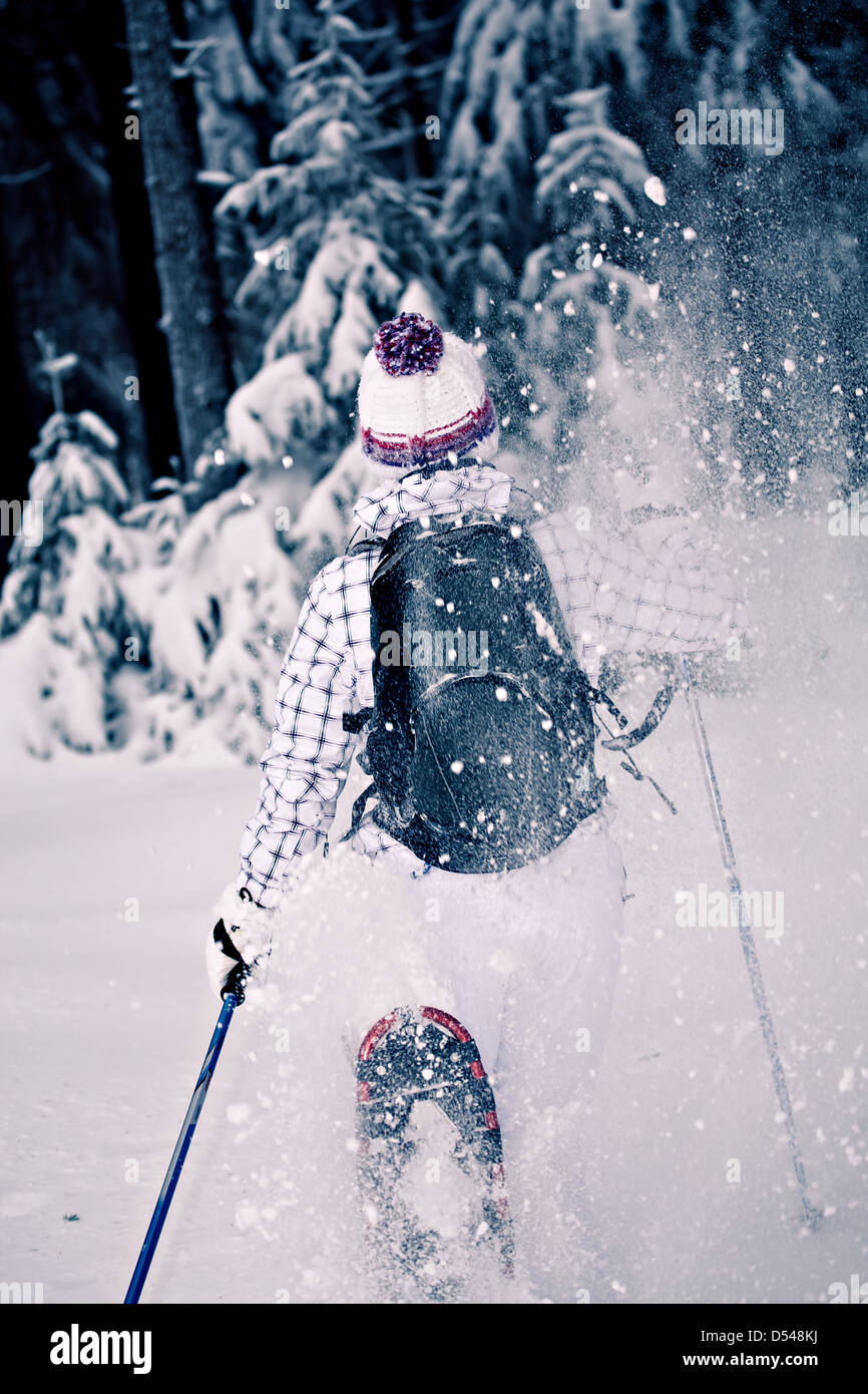 young woman hiking in a snowy forest Stock Photo - Alamy