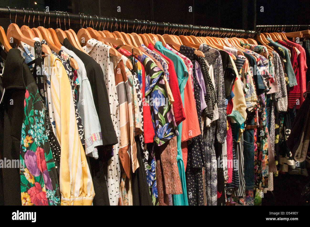 A long clothes rail packed with colurful patterned second hand vintage  dresses at a retro, vintage clothes fair Stock Photo - Alamy