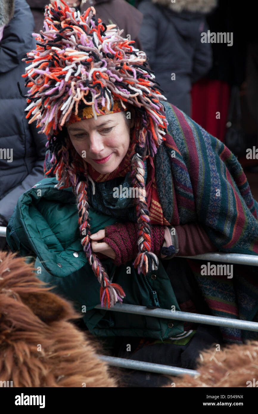 Ramsbottom, Lancashire, UK Sunday 24th March, 2013. Visitor in woolly hat admiring alpaca at the 5th Annual Chocolate Festival, held in Bridge Street, Ramsbottom, last year’s winner of the Manchester Tourism Awards 2012 “Best Small Event.”  A two day chocolate market with al fresco dining, beer tent, Children’s craft sessions, and a mini farm. Stock Photo