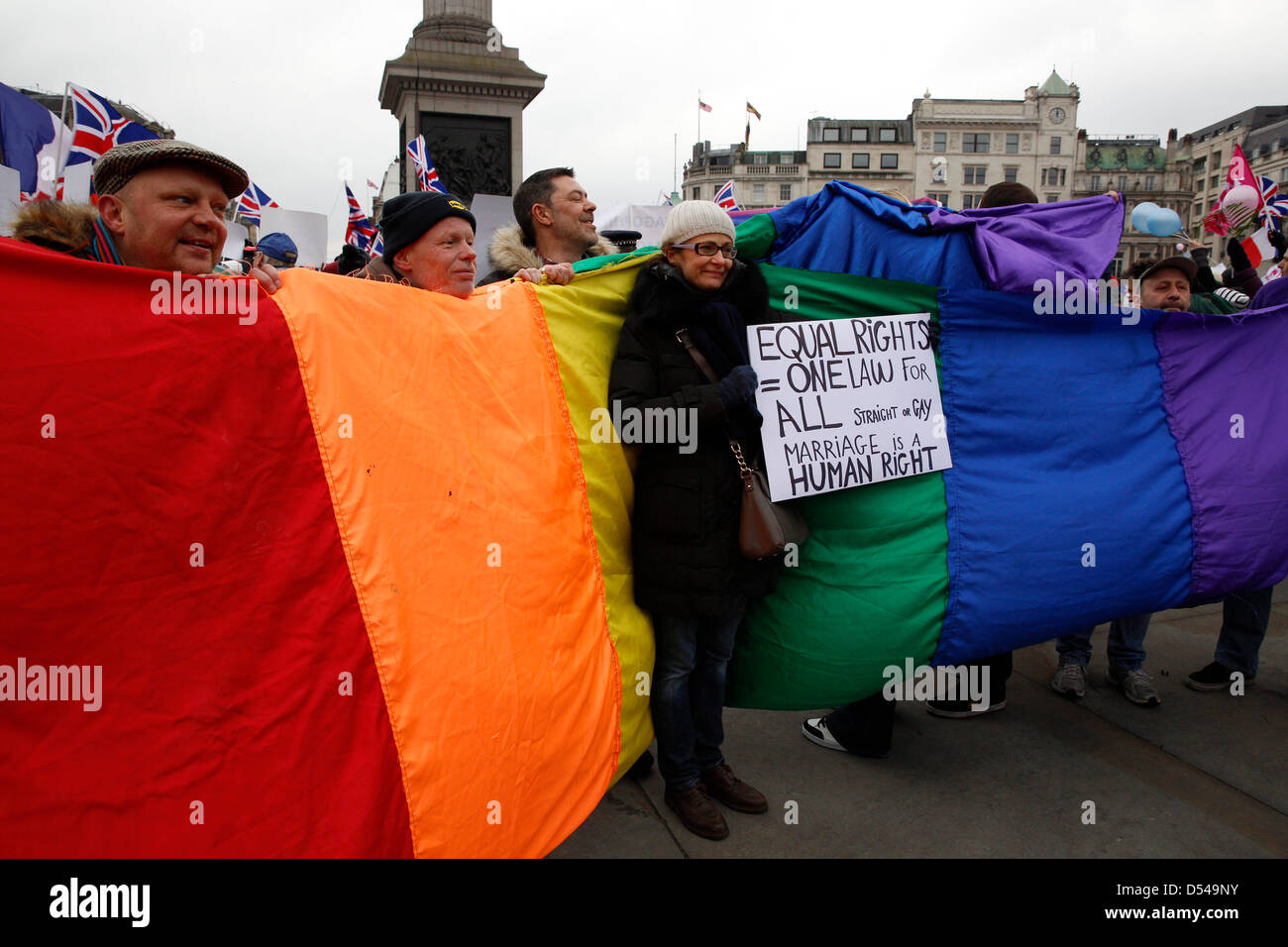 London, UK. 24th March, 2013.  Protesters against homophobia and for gay marriage were holding rainbow flags and placards during the demo. French protesters alongside religious groups are organising an Anti-Gay rally in Trafalgar Square.  Anglican Mainstream are urging Christians to turn up to protest Stock Photo
