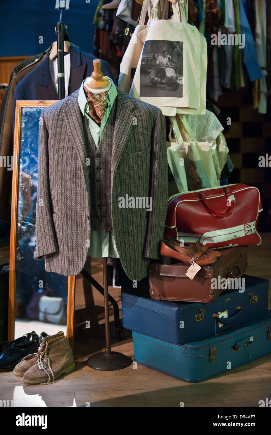 Retro men's jacket, waistcoat and shirt with old 1960s suitcases on display at a vintage market, flea stall Stock Photo