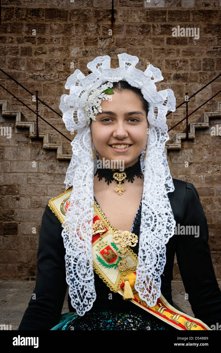 Spanish Girl in Traditional Costume including lace mantilla  veil or shawl during las Fallas or Falles festival in Valencia Spain Stock Photo