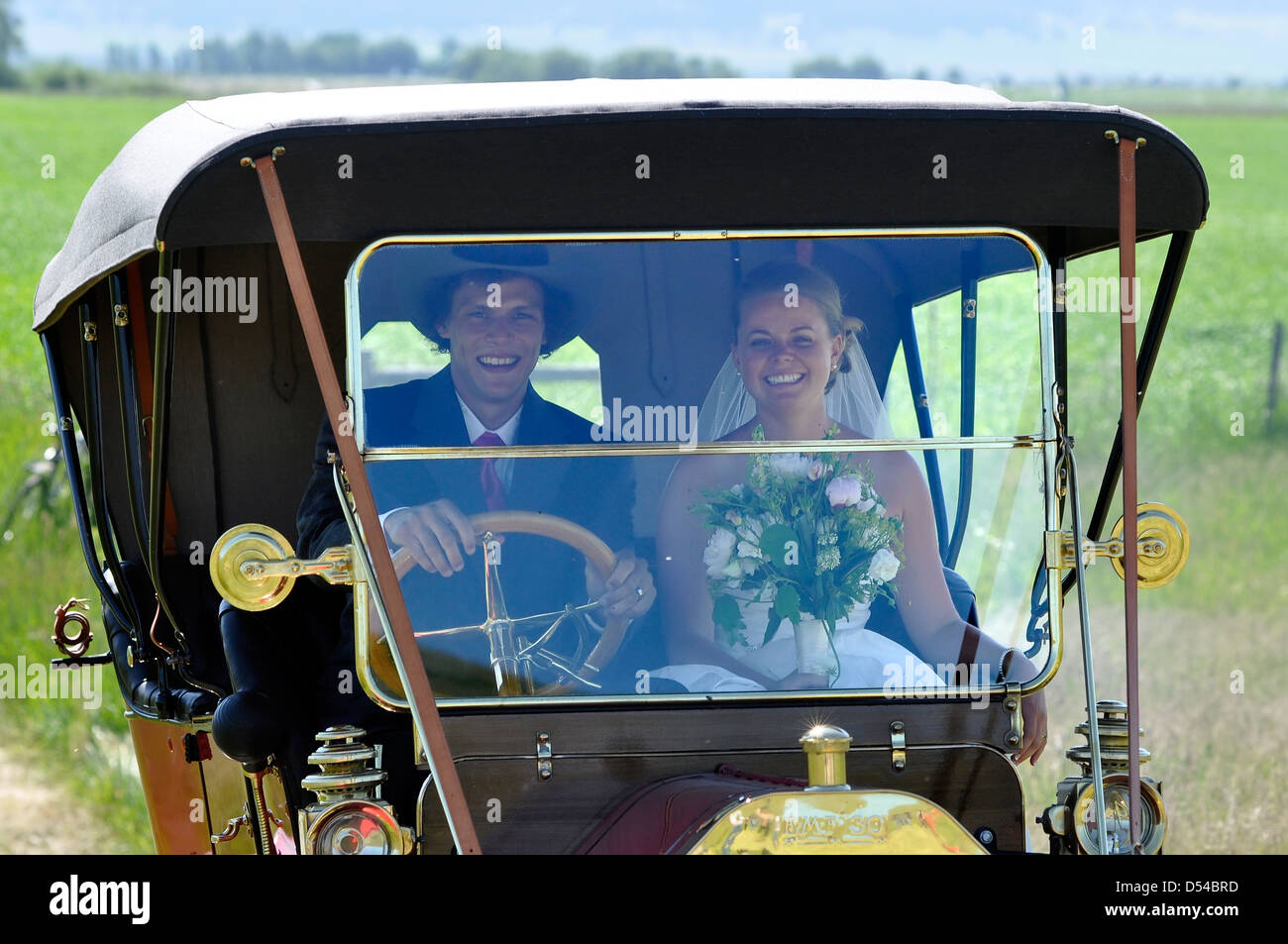 Bride and groom arriving at their wedding ceremony in a vintage car