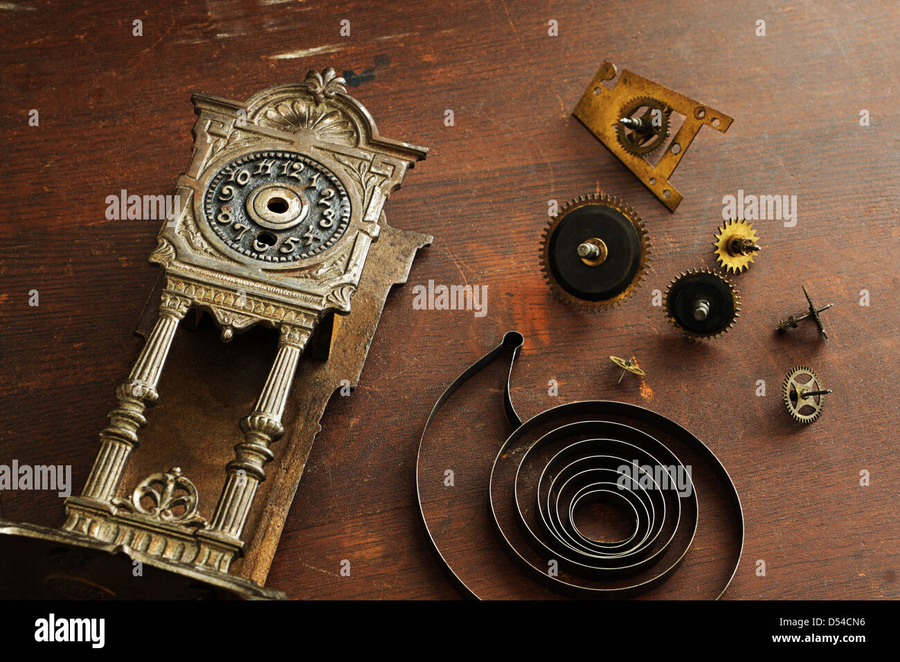 Old broken watches and parts to the clock on a wooden surface Stock Photo