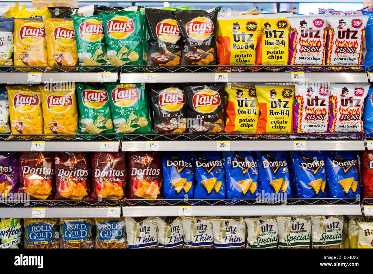 Lay's, Utz and Doritos potato chips on display at a Walgreens Flagship store.  Stock Photo