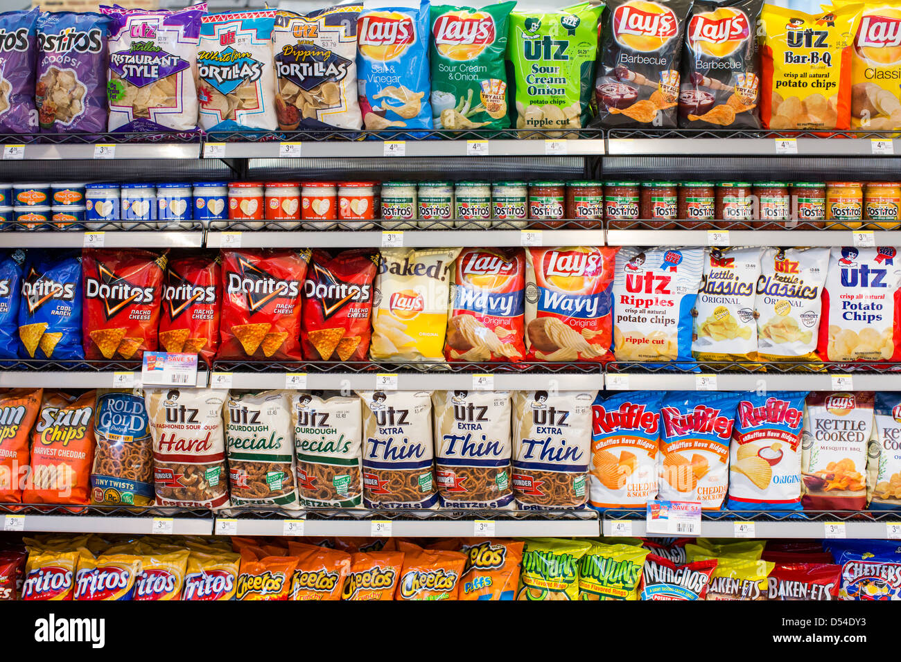 Lay's, Utz and Doritos potato chips on display at a Walgreens Flagship store.  Stock Photo