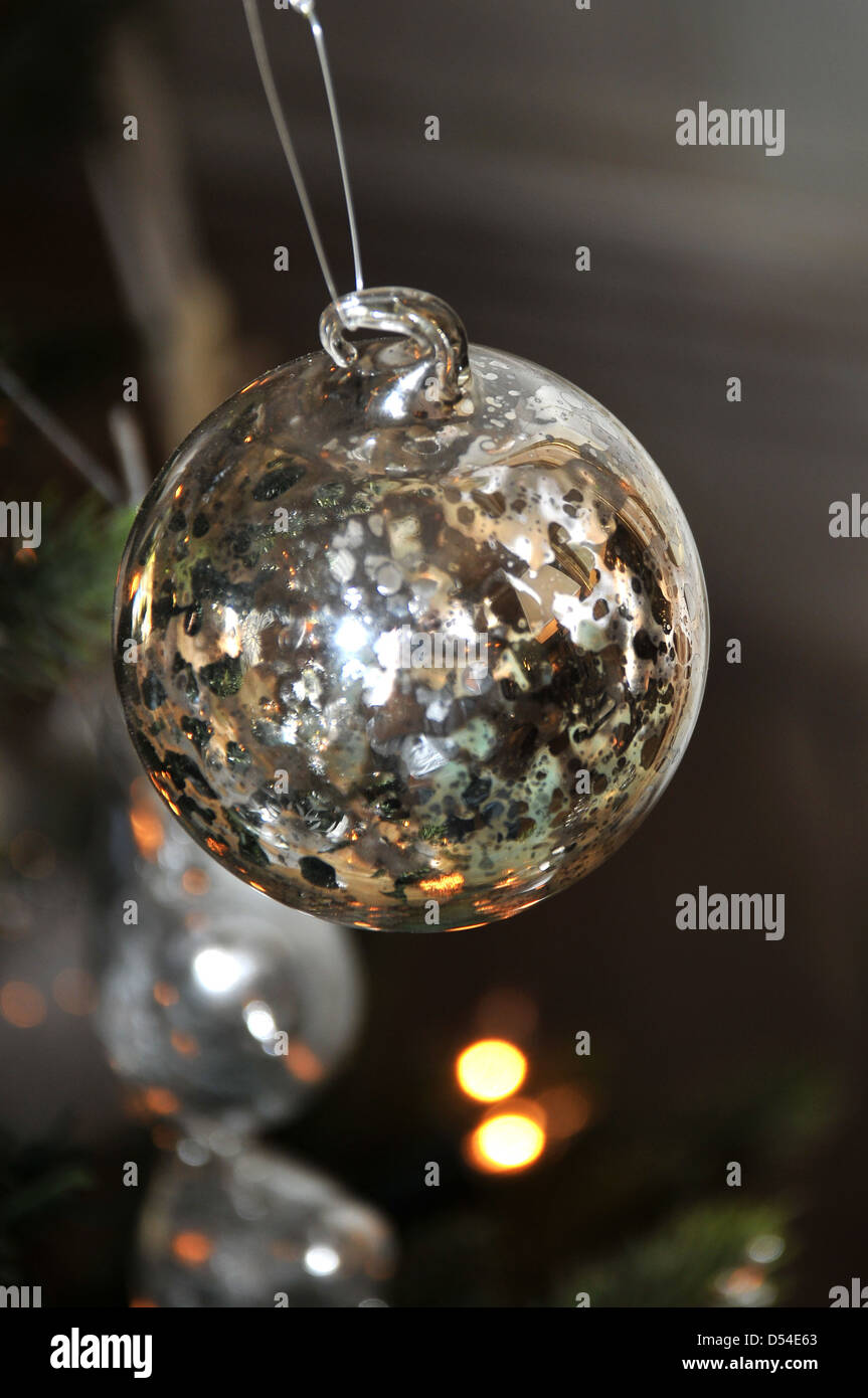 a silver Christmas bauble hanging on a tree Stock Photo - Alamy