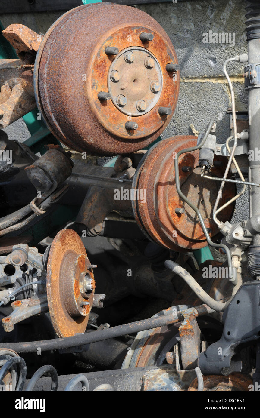 a pile of rusting car parts and scrap metal in scrap yard including