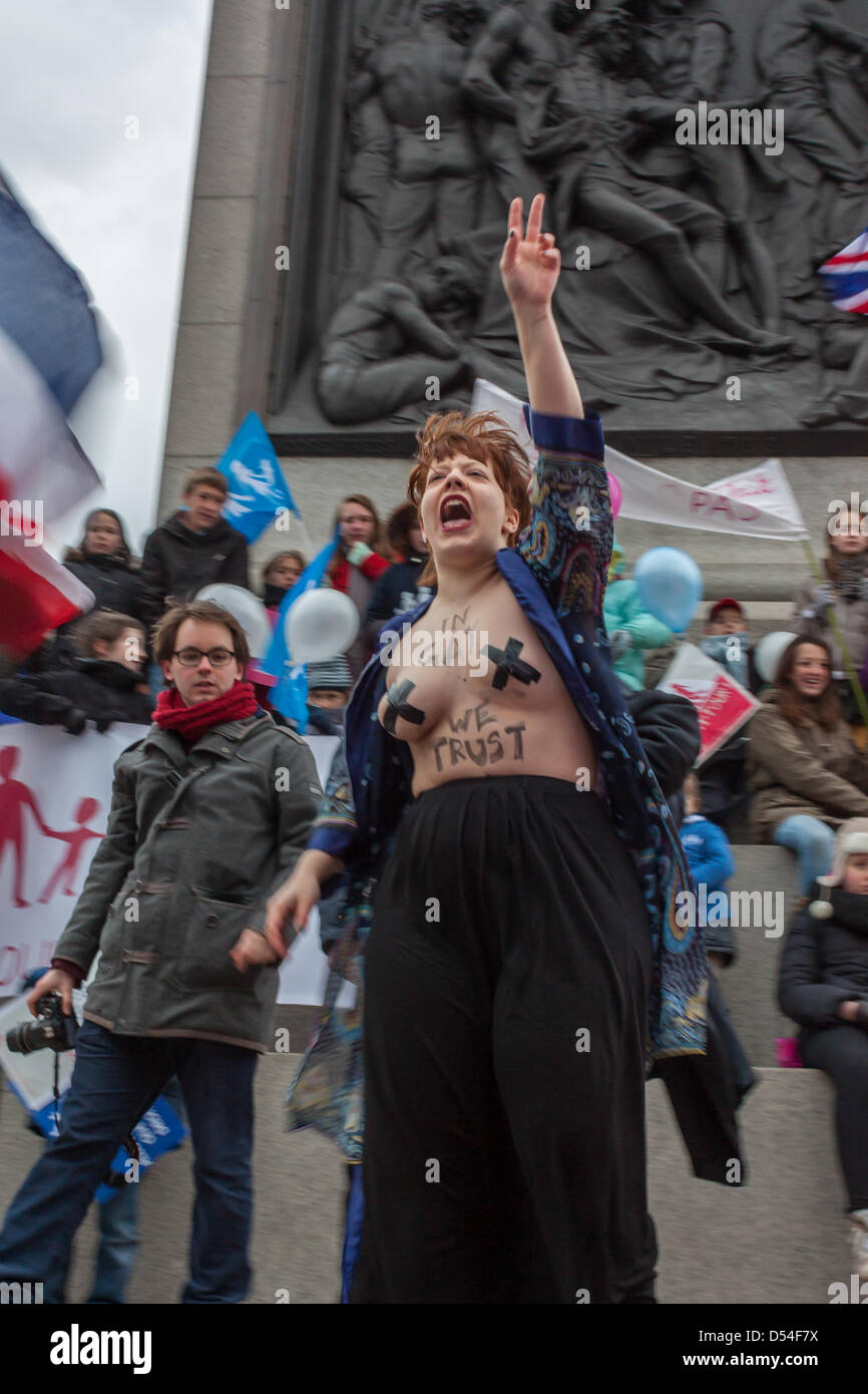 FEMEN member Eliza Goroya takes a stand behind the stage. Protesters on both sides of the argument on marriage equality gathered in Trafalgar Square, London. 24 March 2013. Organisers of the protest La Manif Pour Tous taking place in Paris had organised a simultaneous London event. A counter demonstrations had been organised by LGBT rights supporters. Stock Photo