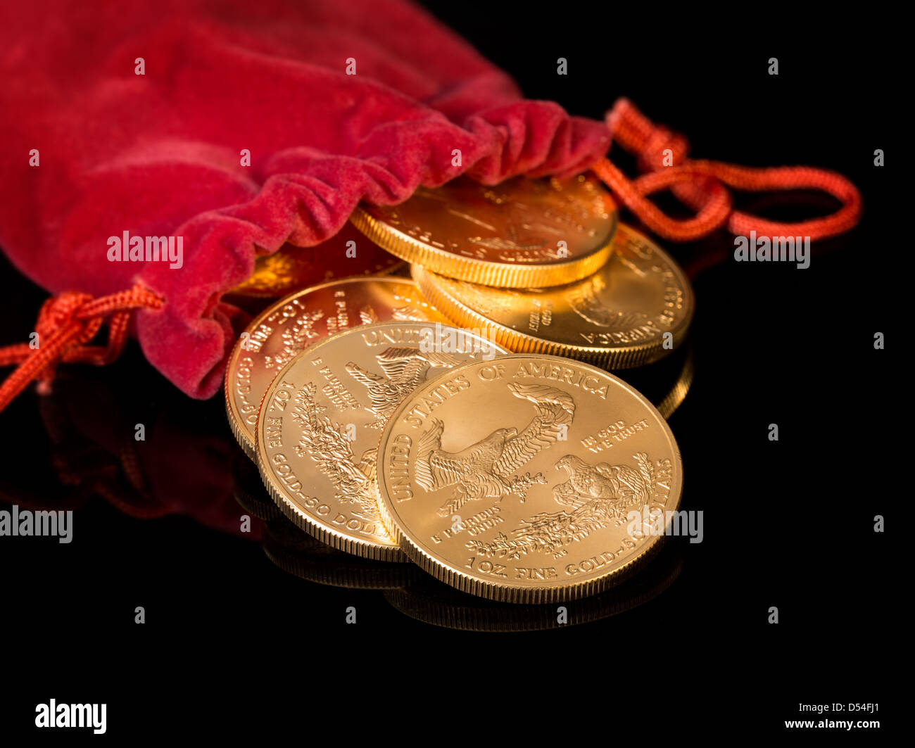 Stacks of gold eagle one troy ounce golden coins from US Treasury mint pouring from mouth of red