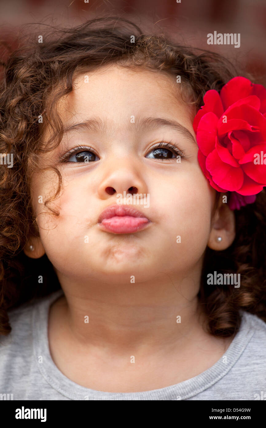 Little girl with flower in her hair Stock Photo - Alamy