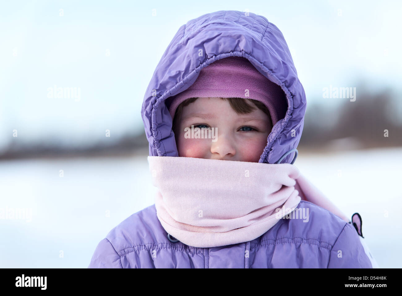 Portrait of wrapped in warm clothes small child in winter season Stock Photo