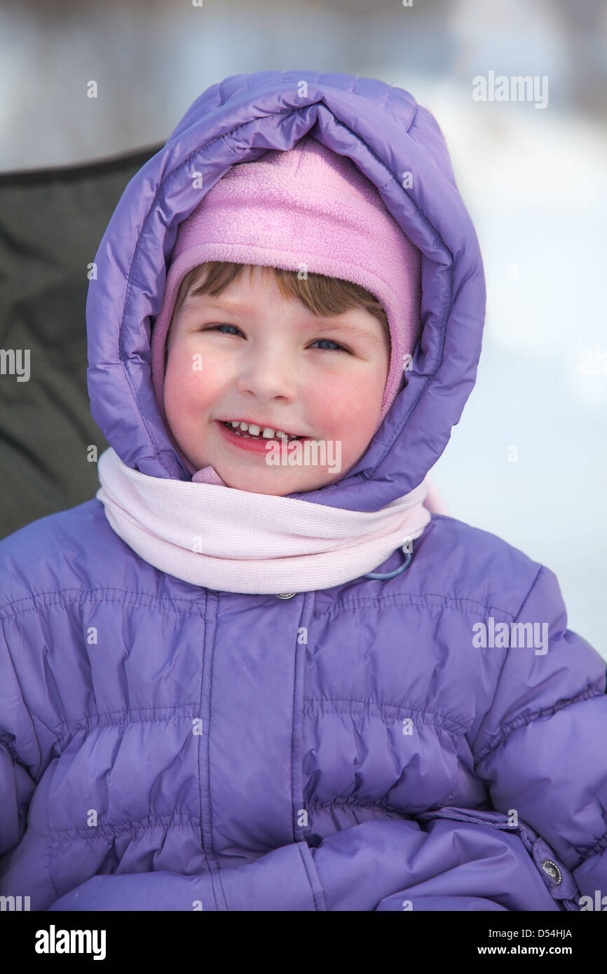 Smiling Caucasian girl in hood with scarf on neck Stock Photo