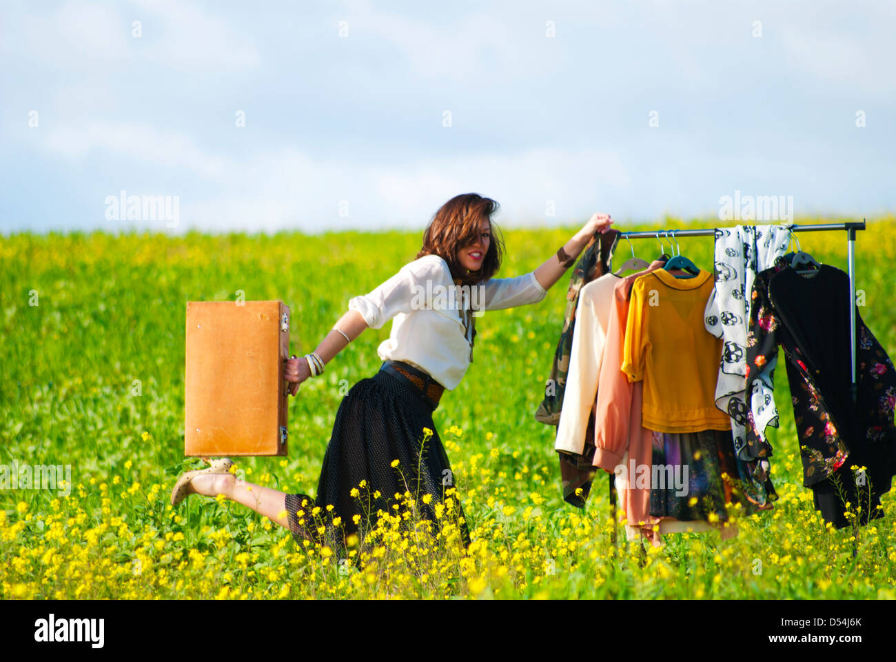 Stylist carrying clothes and suitcase Stock Photo