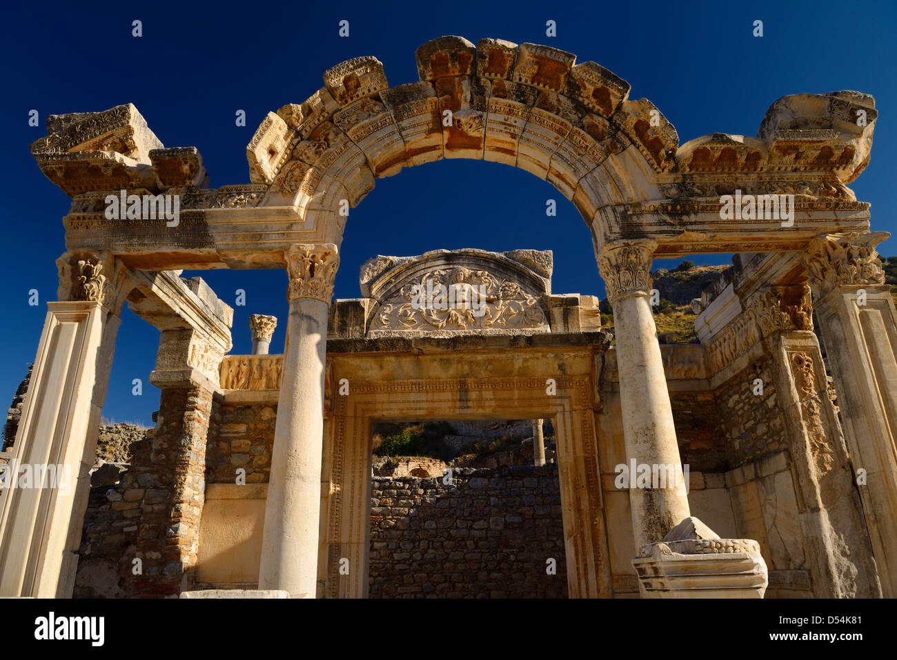 Ornate stone carving facade of the Temple of Hadrian with Tyche Goddess of the city of Ephesus Turkey with clear blue sky Stock Photo