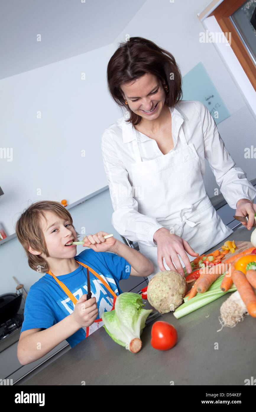 Basel, Switzerland, a woman with child when cooking in the kitchen Stock Photo