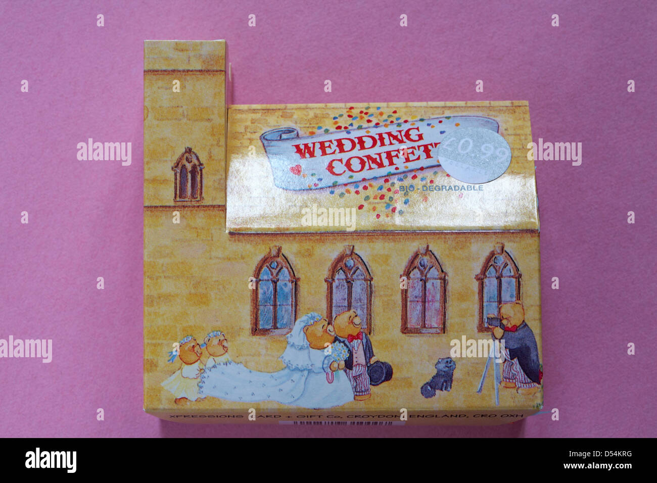 bio-degradable wedding confetti box in shape of church isolated on pink background Stock Photo