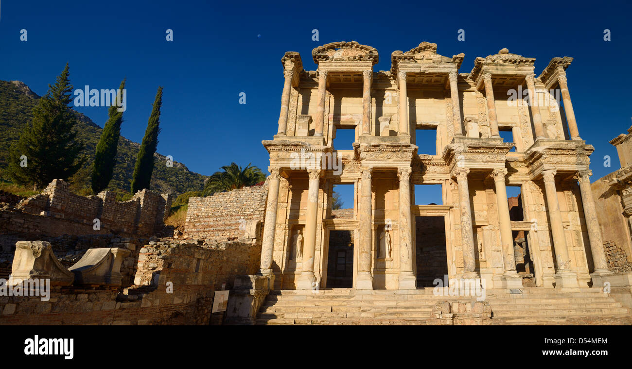 Panorama of ruins of the facade of the Library of Celsus with moon in blue sky at ancient city of Ephesus Turkey Stock Photo