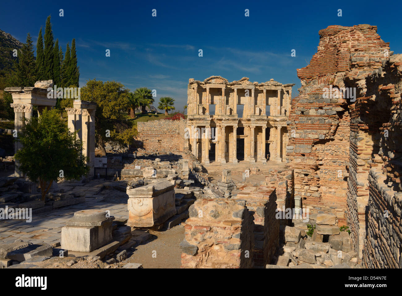 Hadrians Gate pillars and Library of Celsus from Latrine ruins at ancient Ephesus Turkey Stock Photo