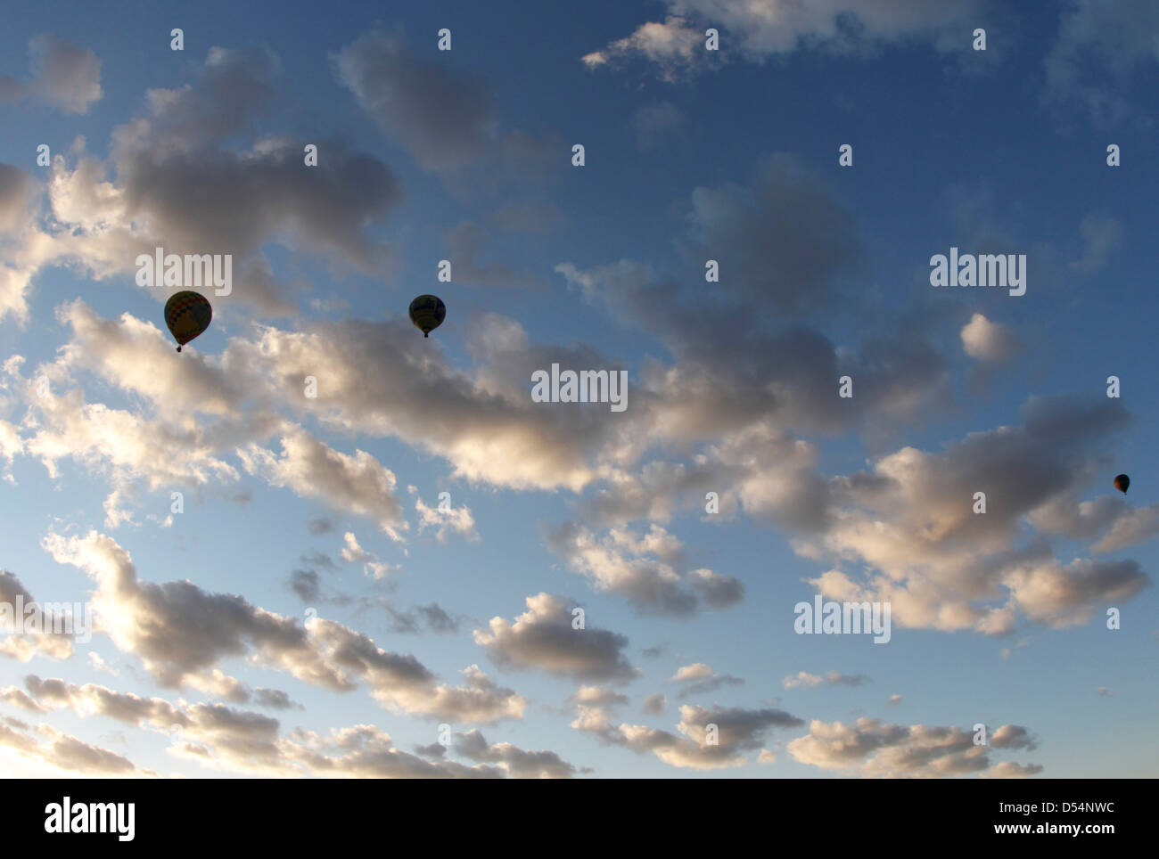 Hot air balloons flying on light cloudy sky. Stock Photo