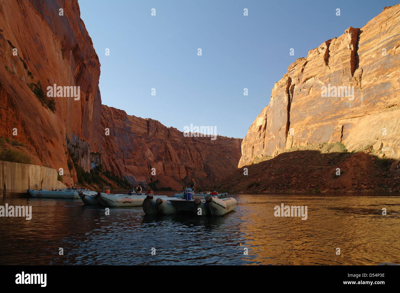 Blue sky brown cliffs canyon Colorado River, with motorise pontoon
