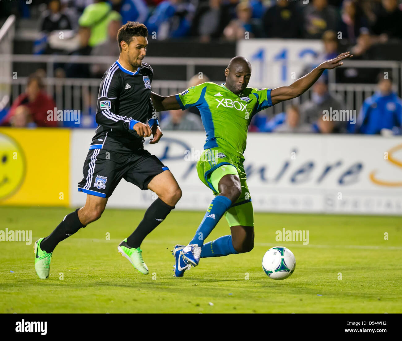 Santa Clara, California, USA. 23rd March 2013. Seattle Sounders defender Djimi Traore (19) takes the ball from San Jose Earthquakes forward Chris Wondolowski (8) during the the MLS game between the Seattle Sounders and the San Jose Earthquakes at Buck Shaw Stadium in Santa Clara CA. San Jose defeated Seattle 1-0. Credit:  Cal Sport Media / Alamy Live News Stock Photo