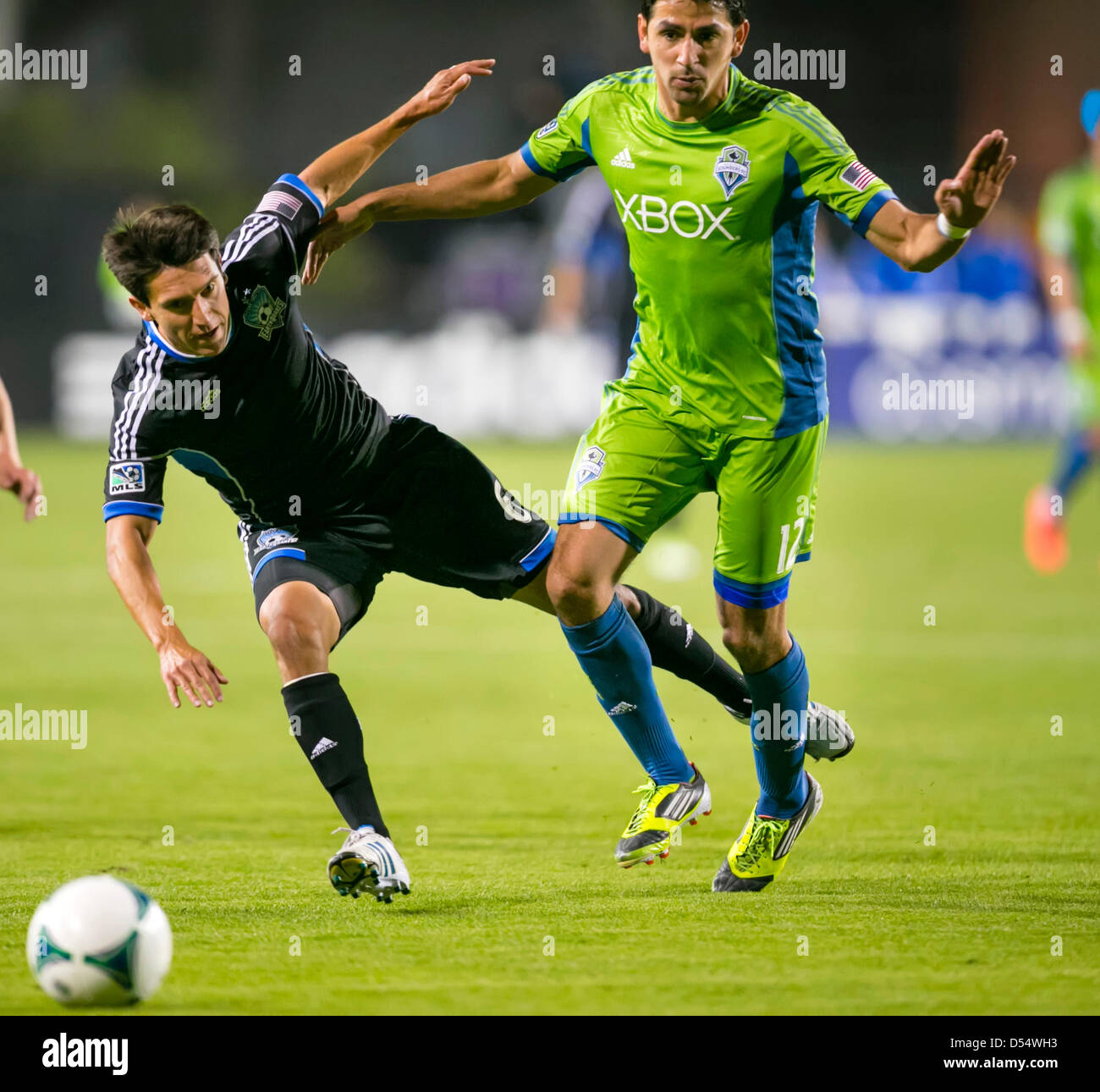Santa Clara, California, USA. 23rd March 2013. Seattle Sounders defender Leo Gonzales (12) knocks San Jose Earthquakes midfielder Shea Salinas (6) off the ball during the the MLS game between the Seattle Sounders and the San Jose Earthquakes at Buck Shaw Stadium in Santa Clara CA. San Jose defeated Seattle 1-0. Credit:  Cal Sport Media / Alamy Live News Stock Photo