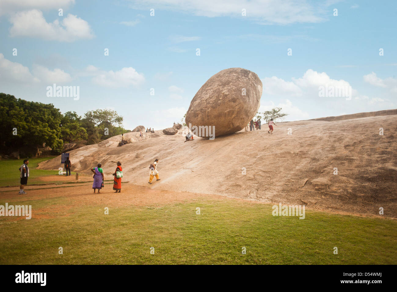 Tourists at the monument of Krishnas Butter Ball, Mahabalipuram, Kanchipuram District, Tamil Nadu, India Stock Photo