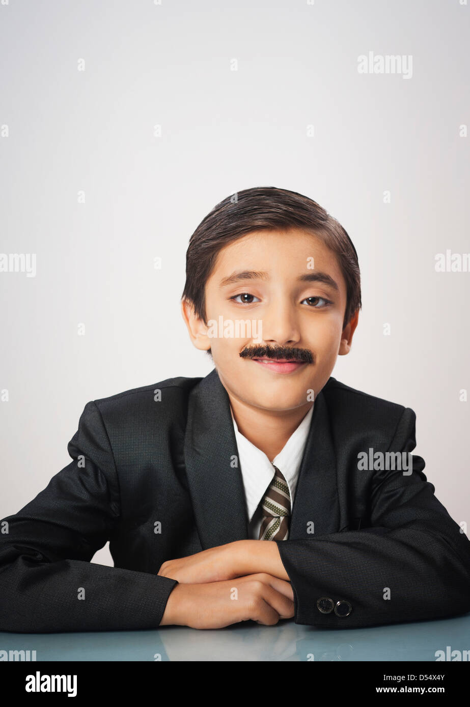 Portrait of a boy imitating like businessman smiling Stock Photo