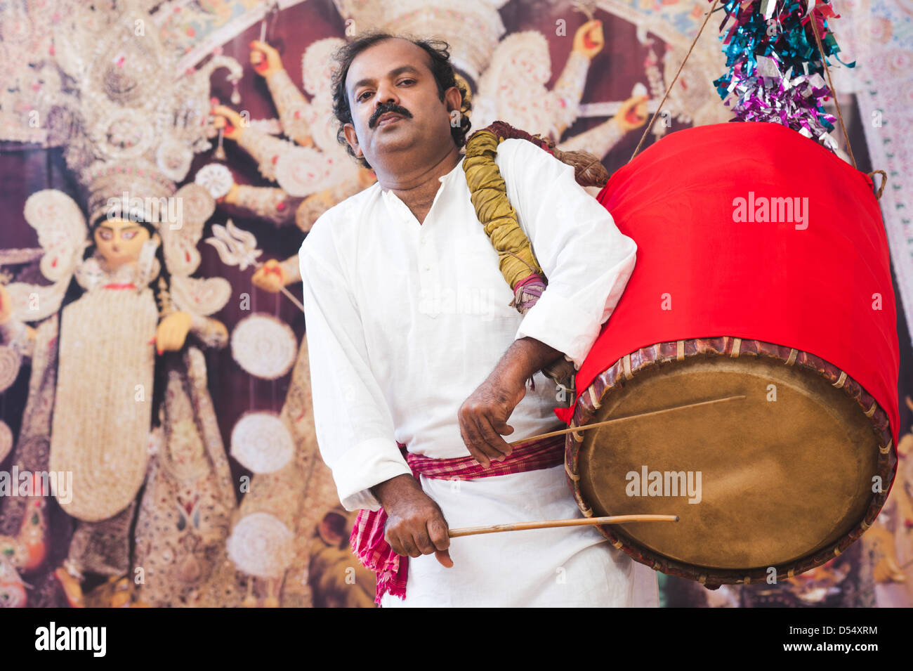 Bengali man playing dhol (A large drum used to play during festival and  celebration in India Stock Photo - Alamy
