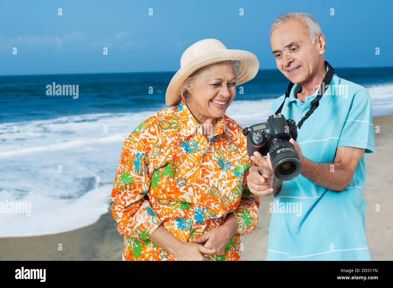 Senior couple looking photographs in a digital camera Stock Photo - Alamy