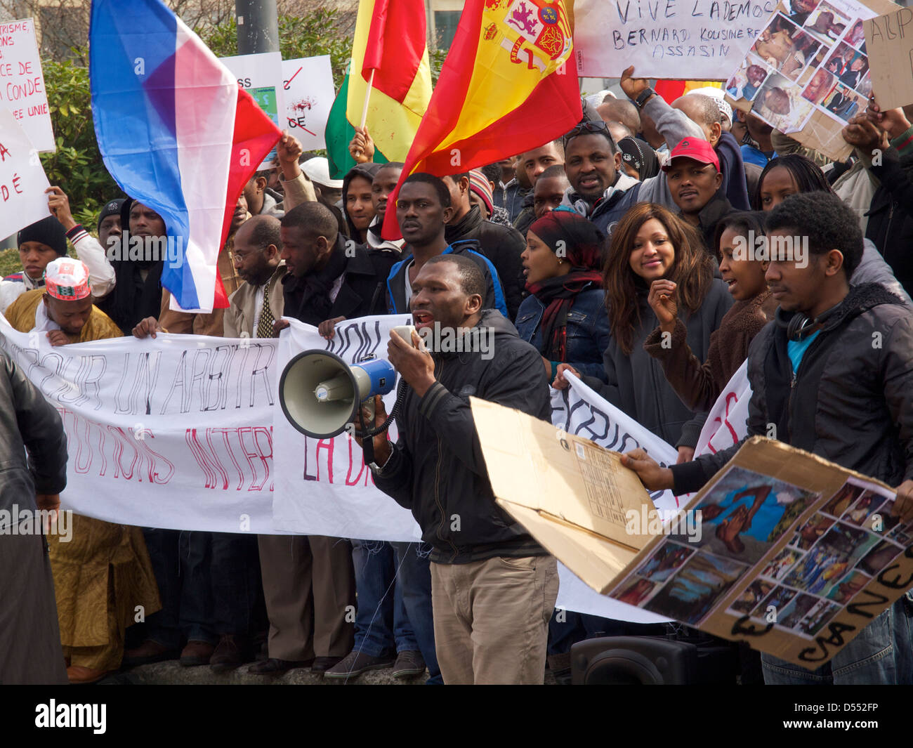 People protesting against dictator Alpha Conde of Guinea with signs with pictures of tortured victims. Brussels, Belgium Stock Photo